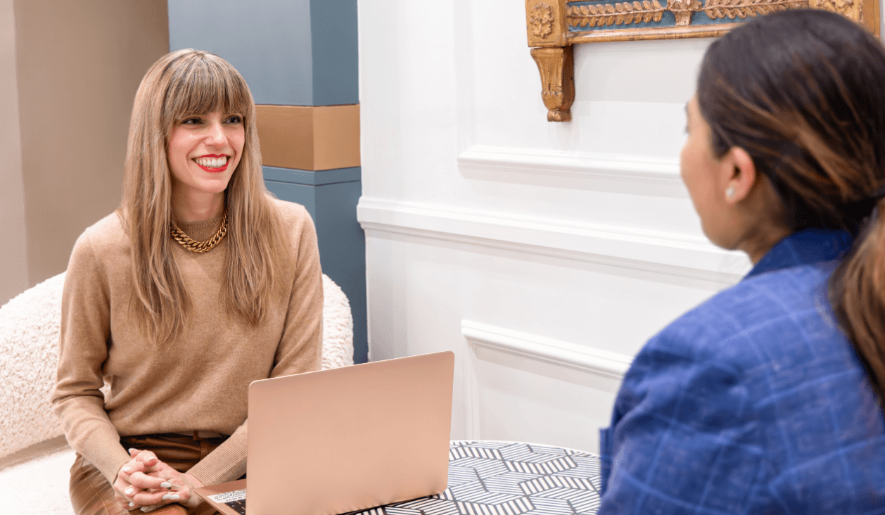 Raquel Macias consulting with a client during a personal styling session, providing expert wardrobe guidance in a professional setting.